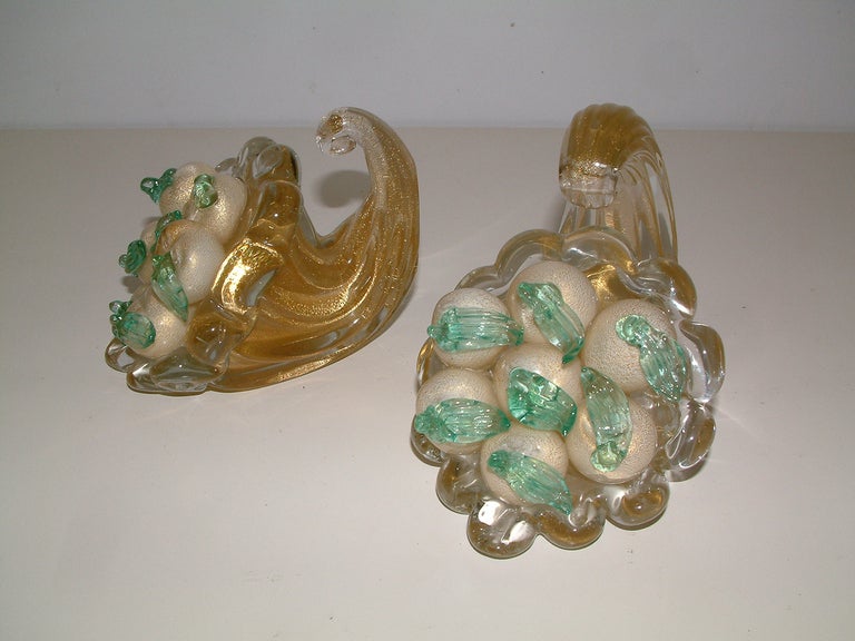 A fine and very rare pair of shadow ribbed cornucopia bookends of opaque white, green and clear glass with gold inclusions.  The bookends are attributed to the work of Archimede Seguso. One glass fruit has a small annealing crack on the underside